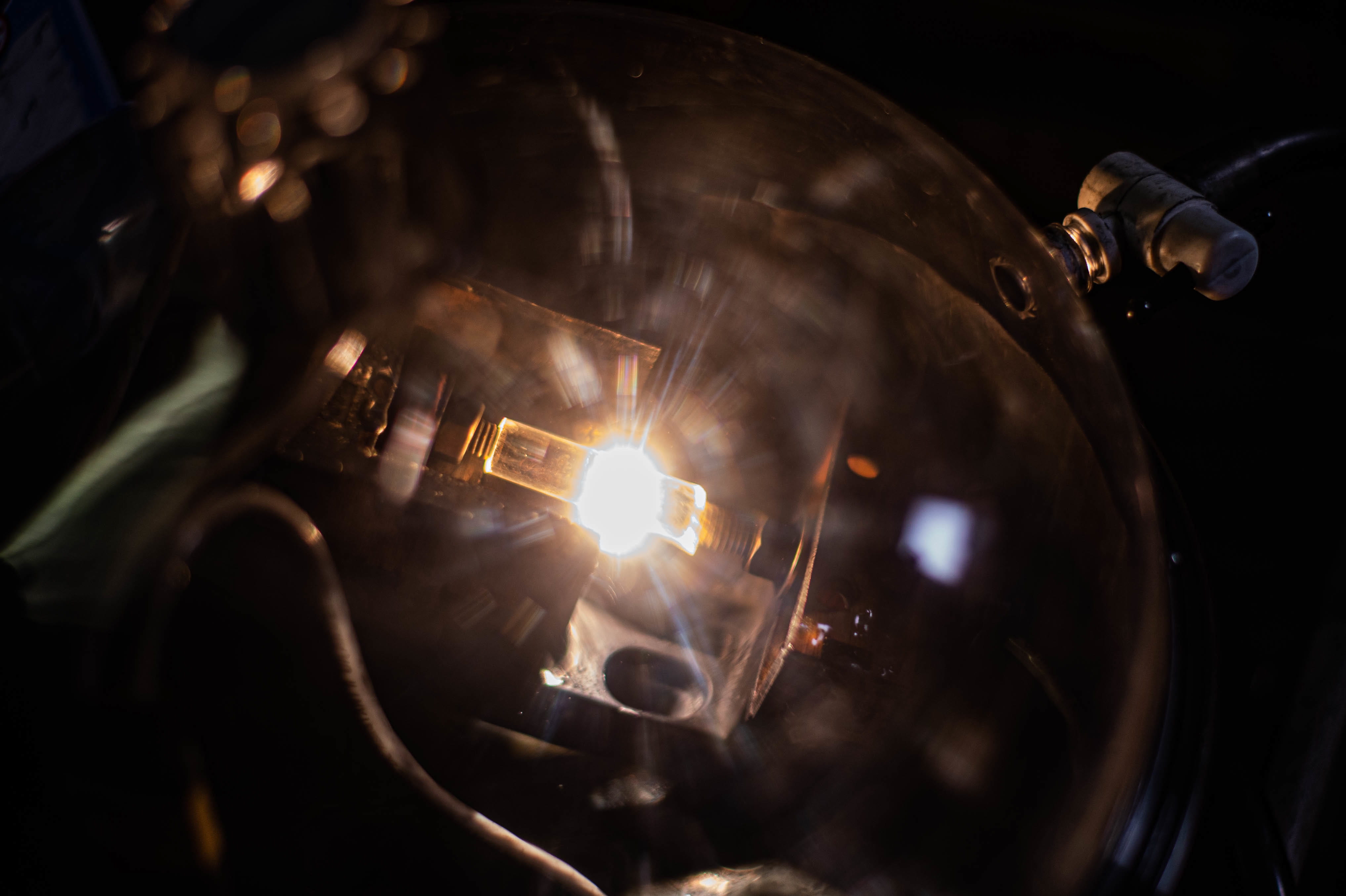 A burst of light illuminated an enclosed glass chamber in the dark